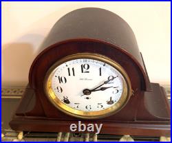 Antique Seth Thomas mantel clock with wood case and brass-tone bezel