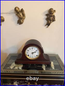 Antique Seth Thomas mantel clock with wood case and brass-tone bezel