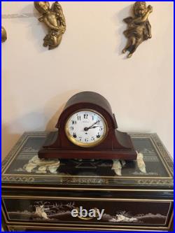 Antique Seth Thomas mantel clock with wood case and brass-tone bezel