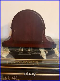 Antique Seth Thomas mantel clock with wood case and brass-tone bezel