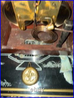 Antique Seth Thomas mantel clock with wood case and brass-tone bezel