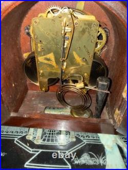 Antique Seth Thomas mantel clock with wood case and brass-tone bezel