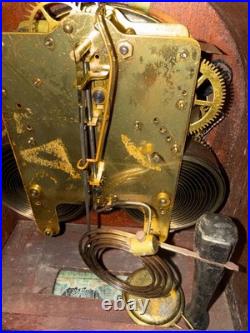 Antique Seth Thomas mantel clock with wood case and brass-tone bezel